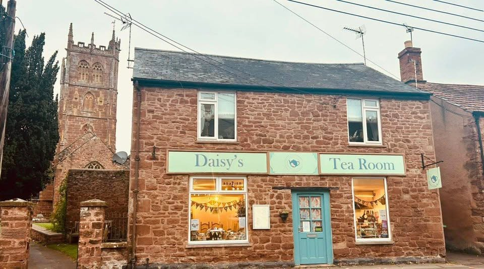 The stone frontage of Daisy's Tea Room beside the church in Bishops Lydeard